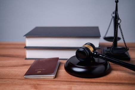 The immigration officer brought down the gavel of justice on the table, symbolizing the importance of following immigration law and the consequences of breaking it.